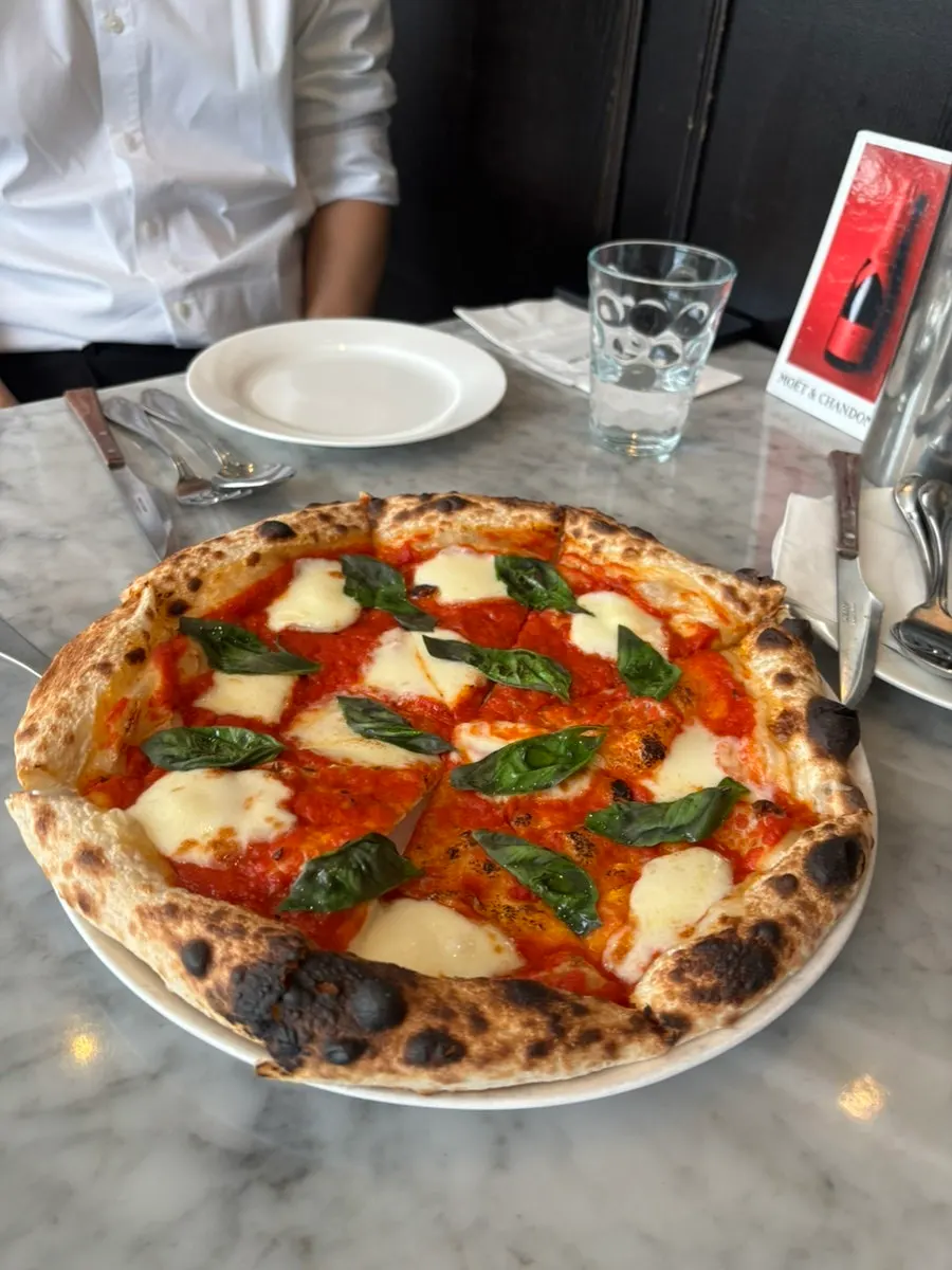 A slice lifted from the Margherita pizza