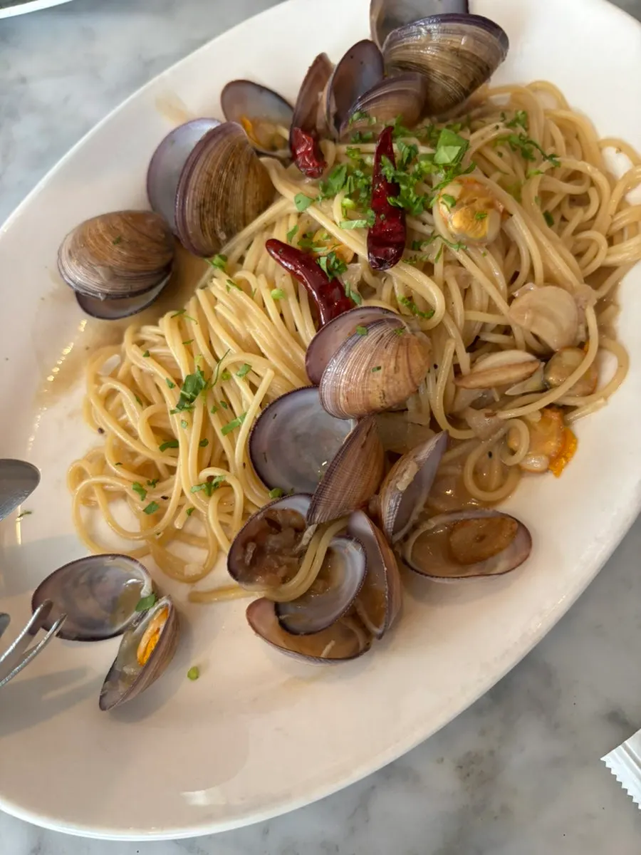Twirling noodles from the vongole pasta with a fork