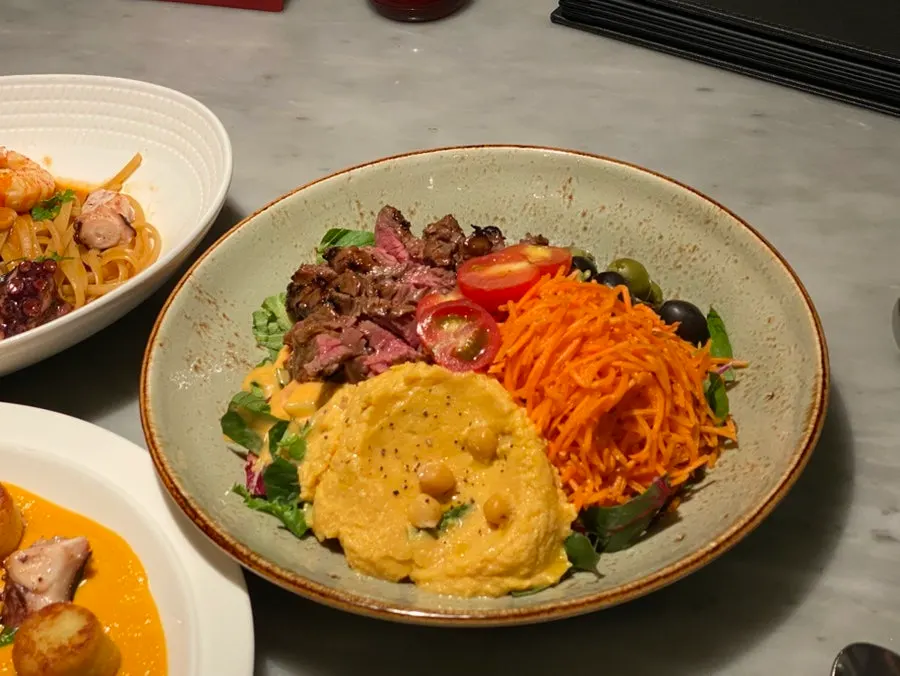 Steak plated over hummus