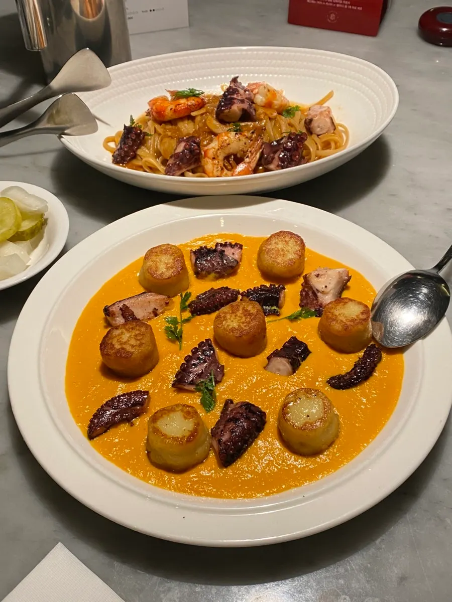 Plate of carrot puree and octopus gnocchi