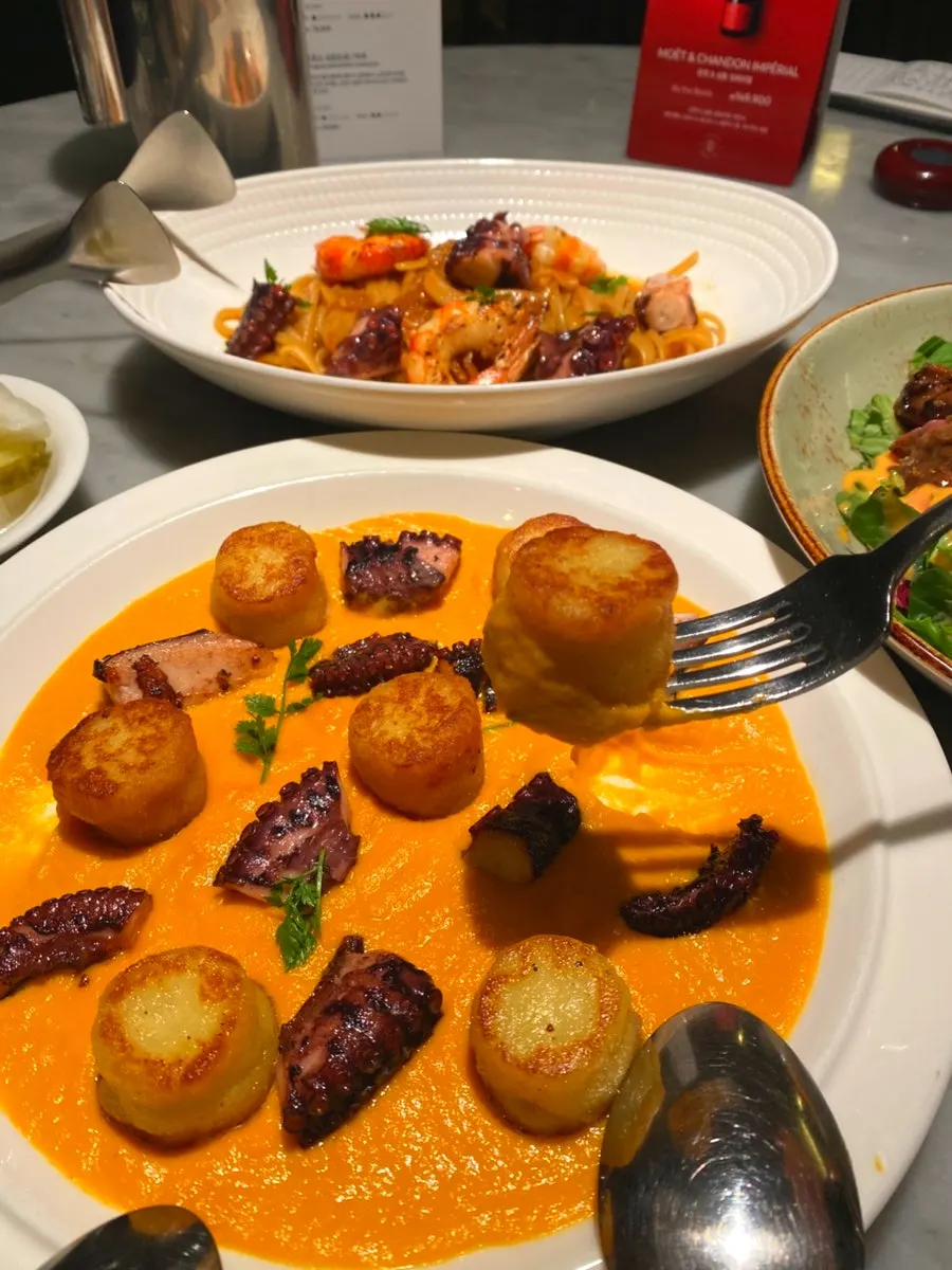 A bite of soft carrot puree and gnocchi