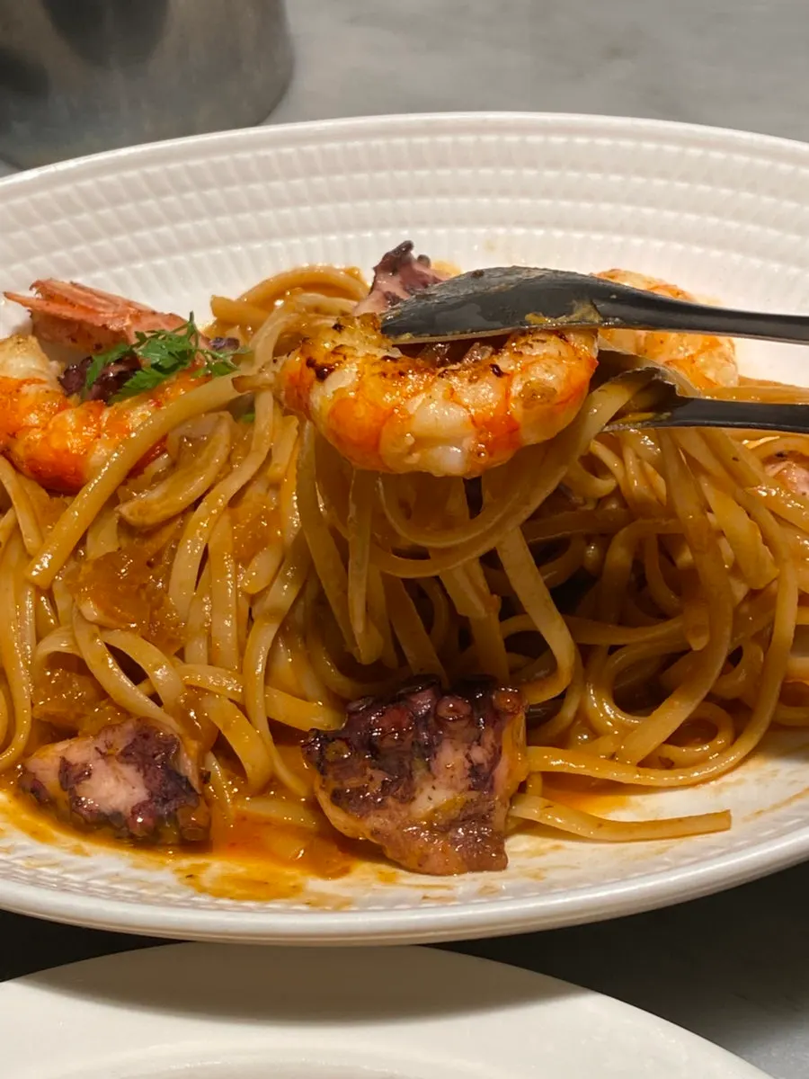 Red shrimp bisque linguine twirled on a fork