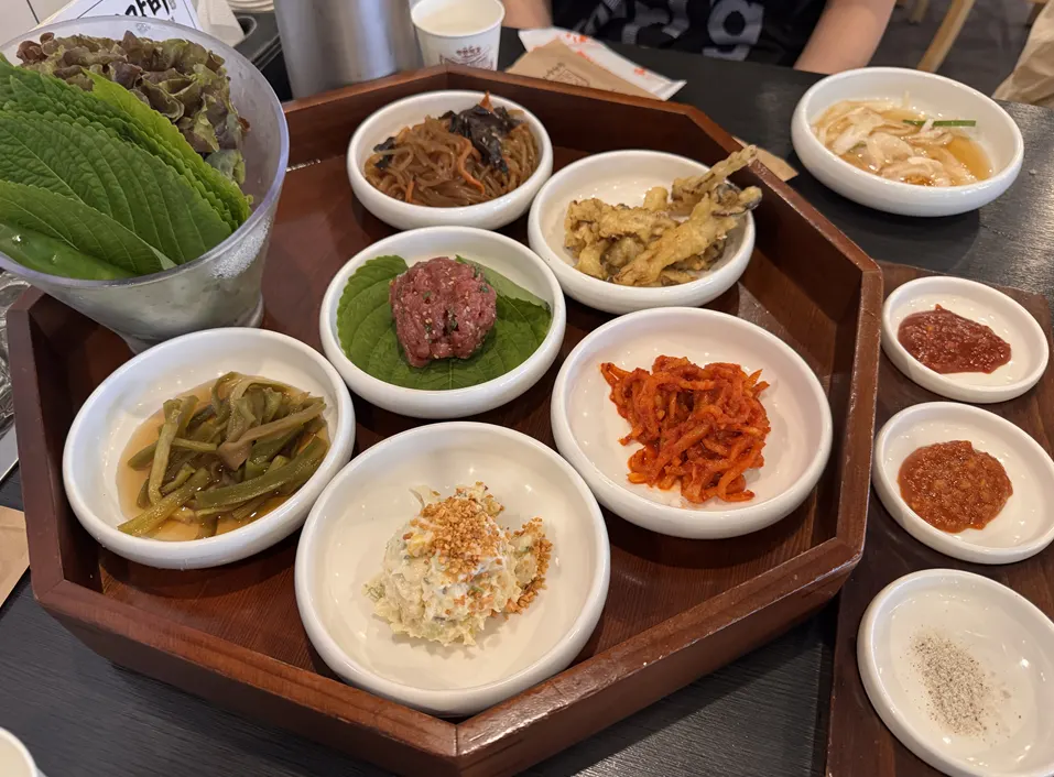 Side dishes and a taste of yukhoe on the table
