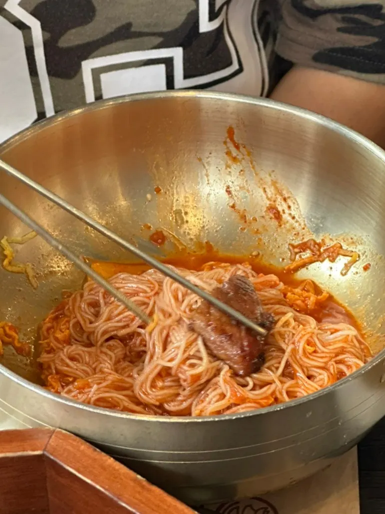 A chopstick-full of bibim-naengmyeon