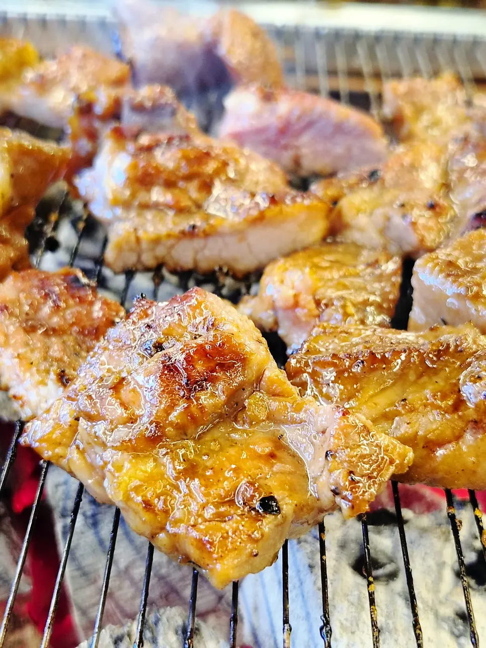 Handmade Hanwoo pork galbi lined up on charcoal grill