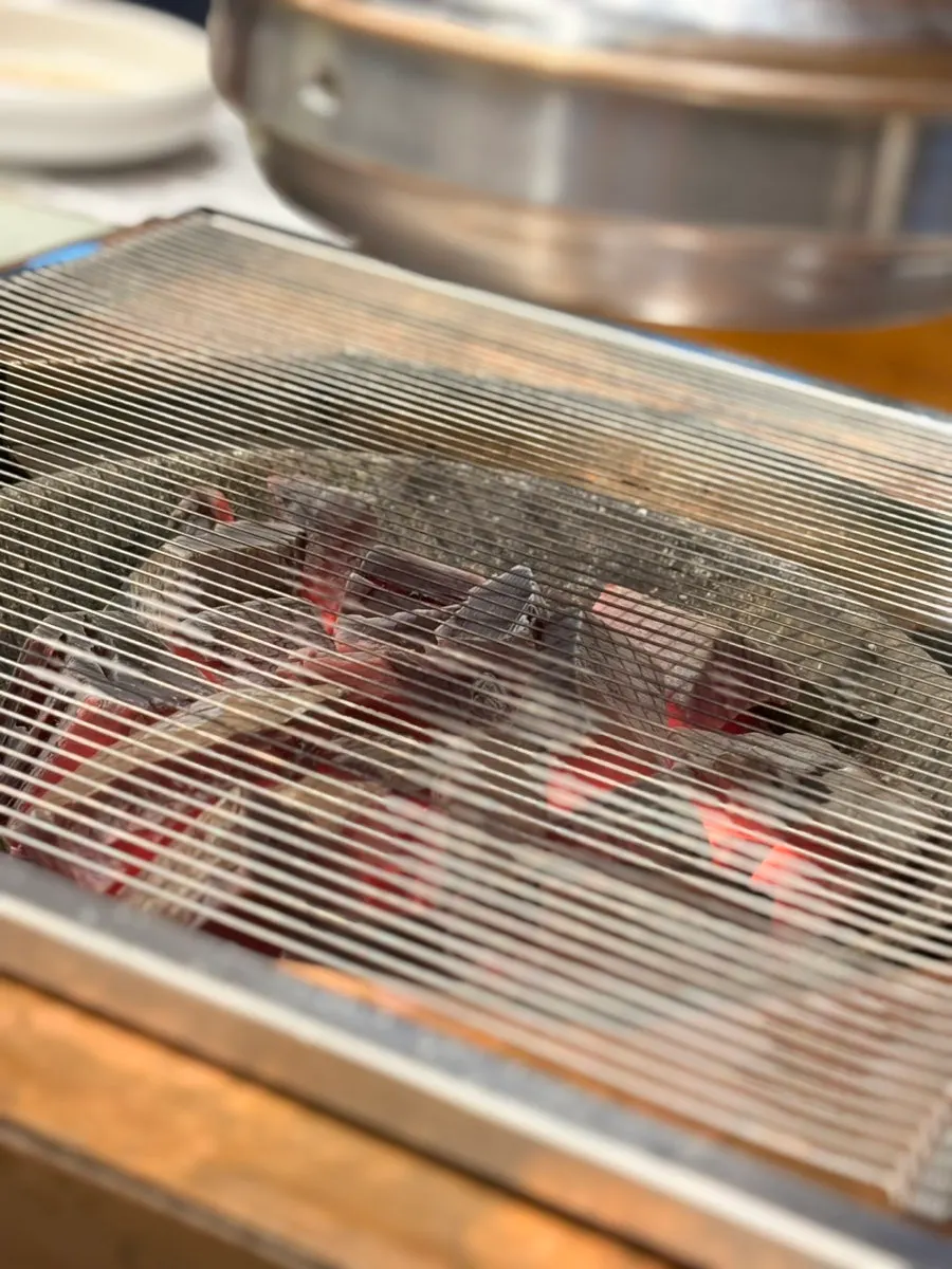 Three servings of handmade marinated galbi on the charcoal grill