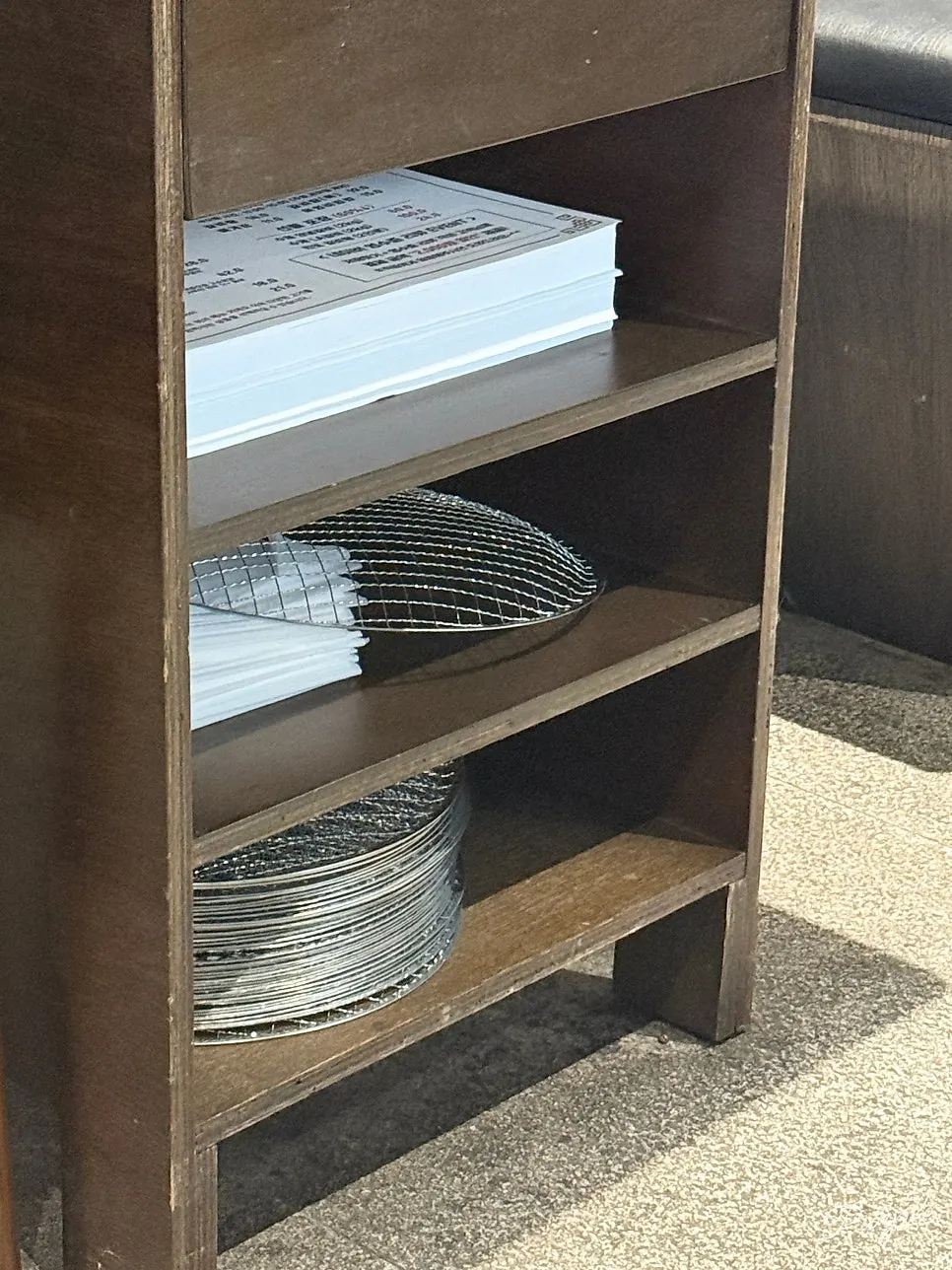 Aprons stored in a drawer under the table