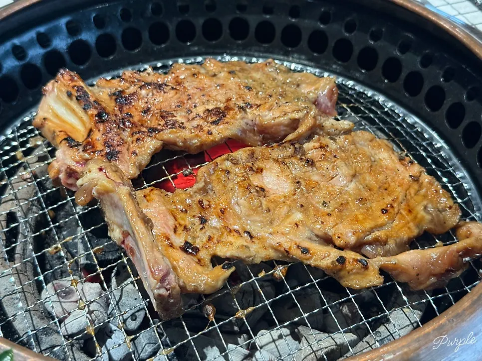 Handmade galbi cooking over charcoal at Manpo Garden