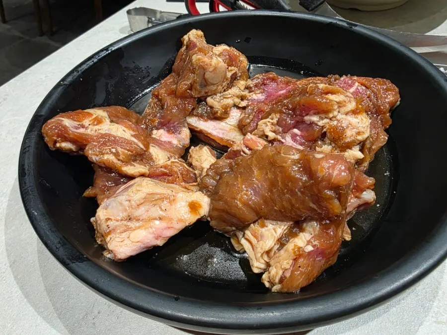 Side dishes arranged in a circle around the grill