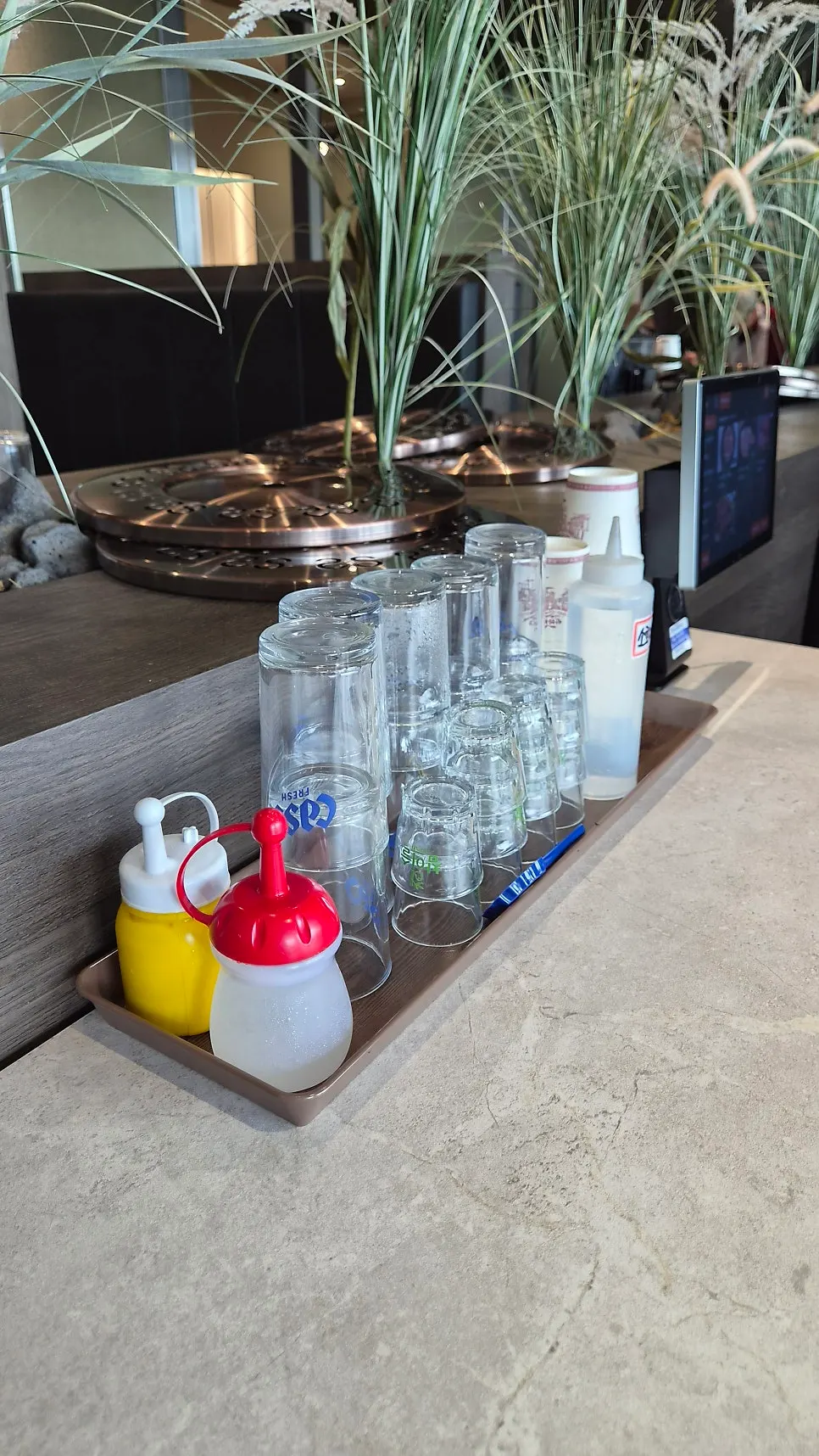 Table setting at Manpo Garden with individually wrapped utensils in a drawer