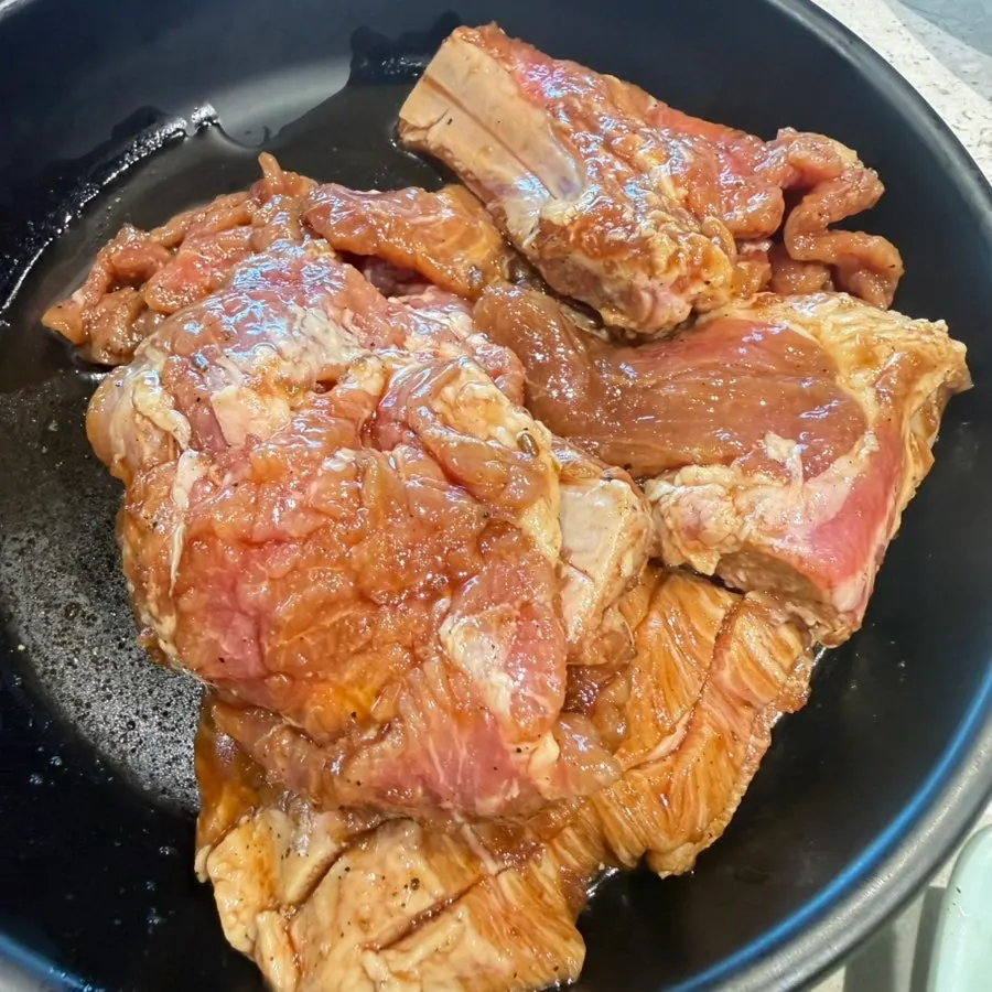 Plate of raw handmade galbi with the bone attached at Manpo Garden