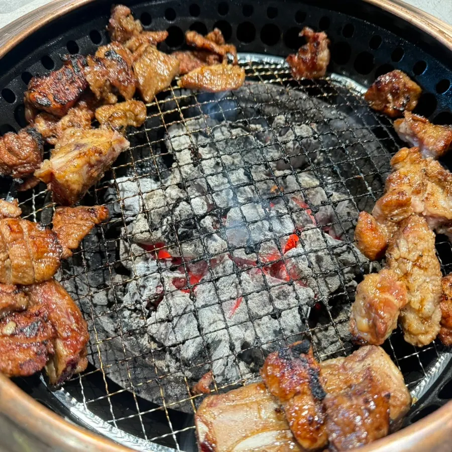 Manpo Garden's pork galbi grilling over charcoal