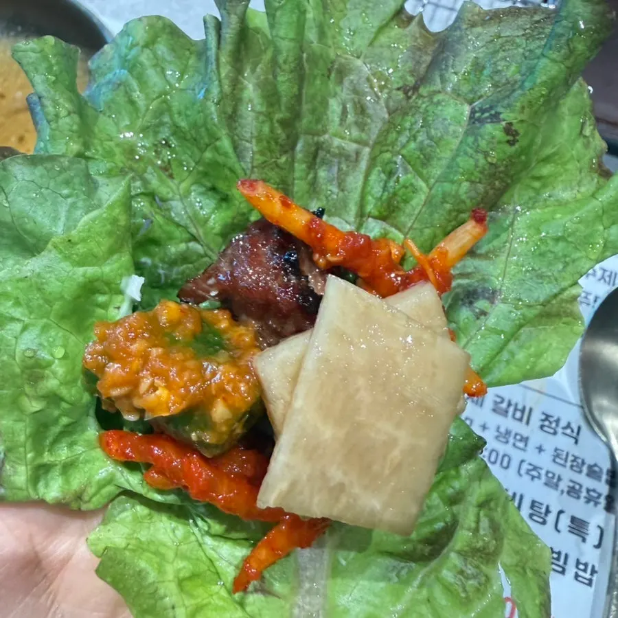 A piece of Manpo Garden's handmade galbi with side dishes