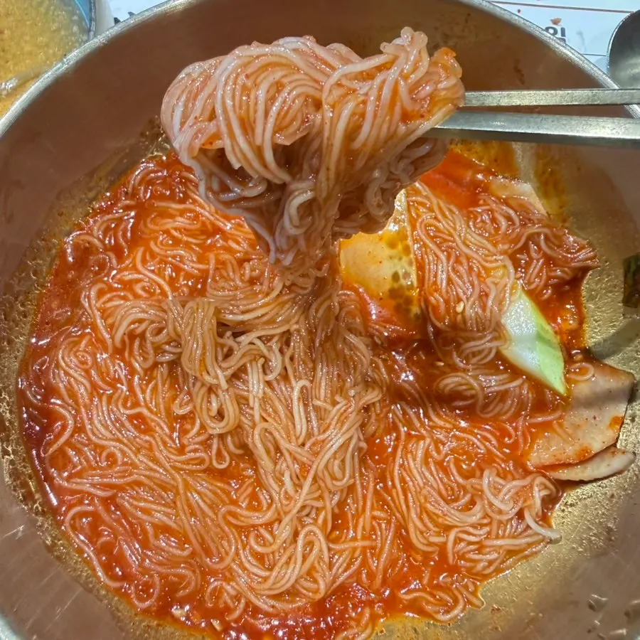 Chewy Hamhung-style naengmyeon noodles lifted up