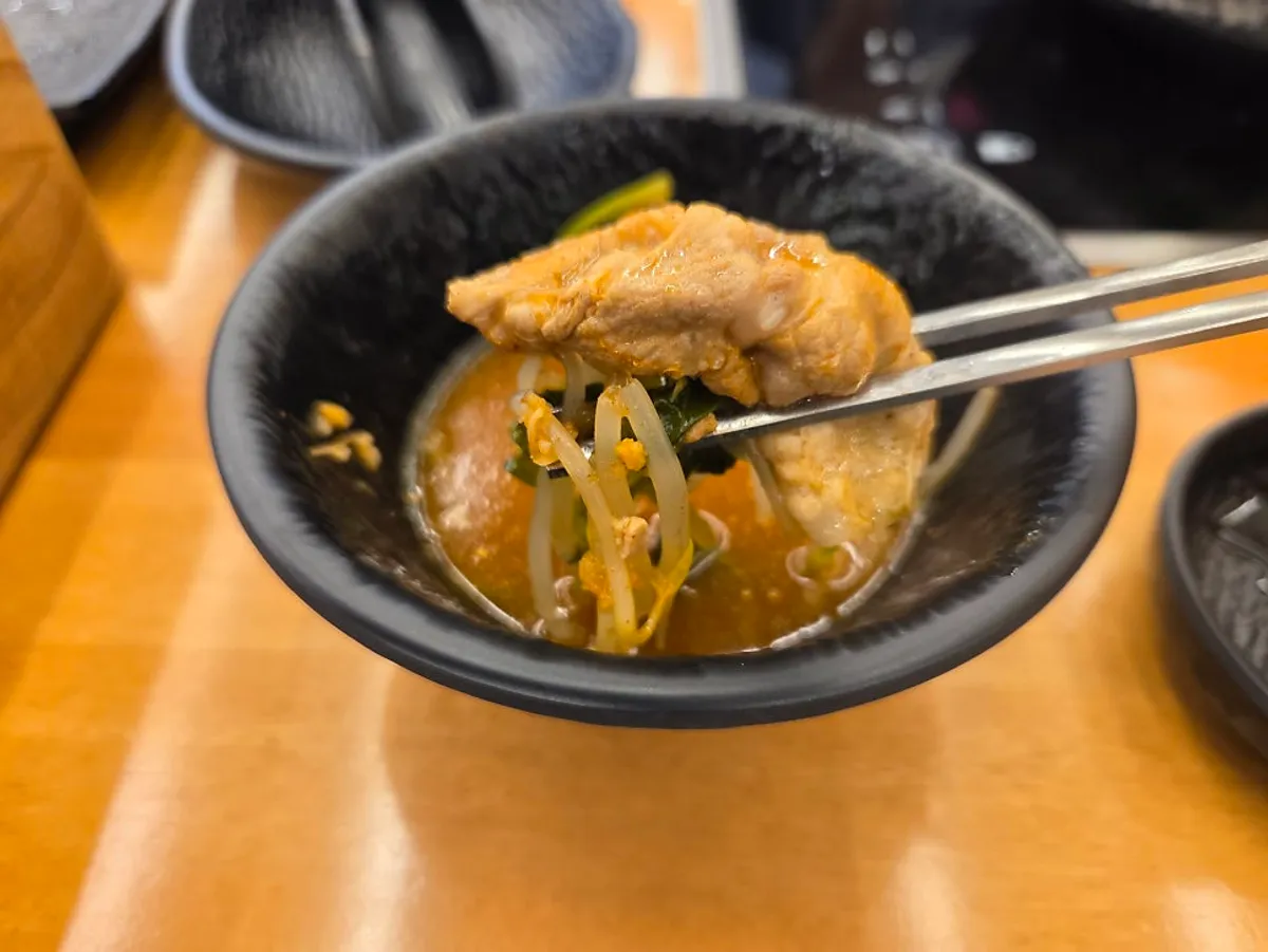 A bowl of Mansu Shabu Kalguksu's spicy pork belly shabu-shabu