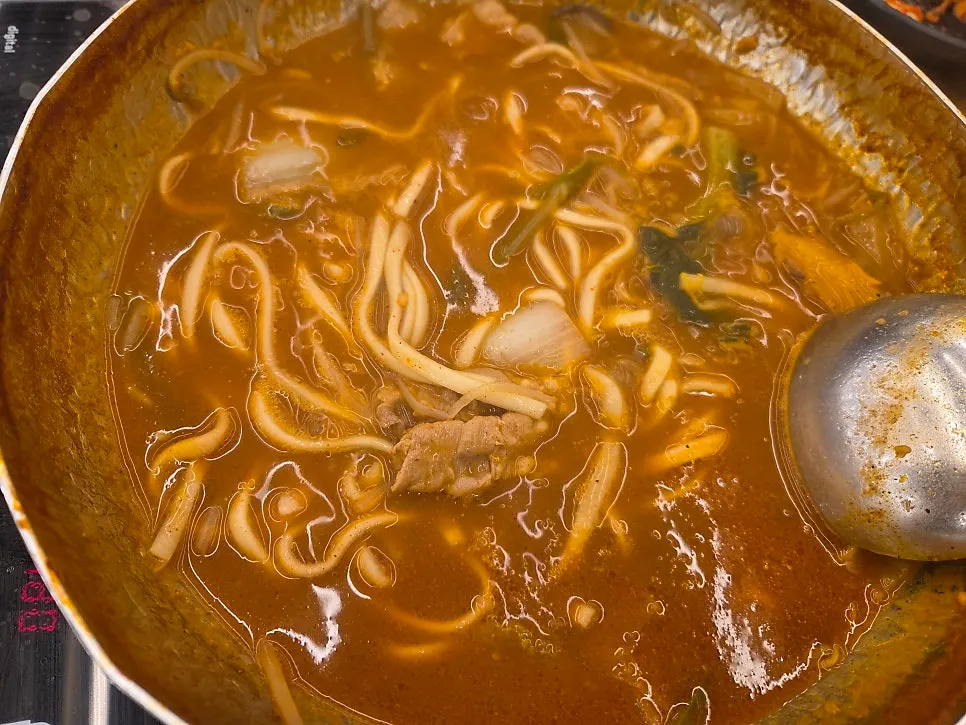 A piece of pork belly cooked in the spicy broth