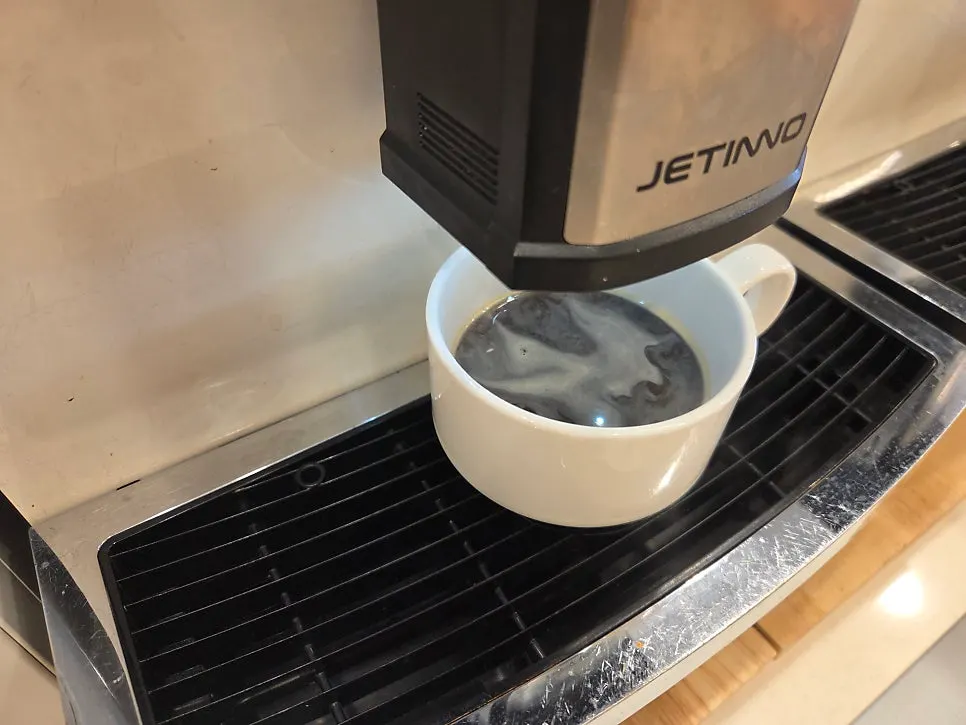 A hot americano poured from the self-serve corner