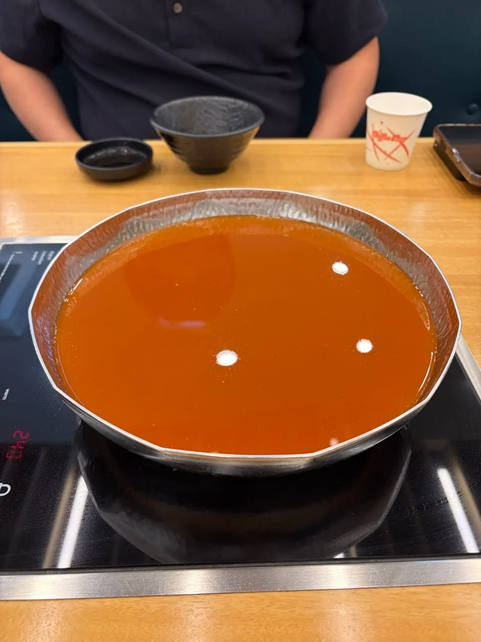 Pot of the spicy shabu-shabu broth we ordered