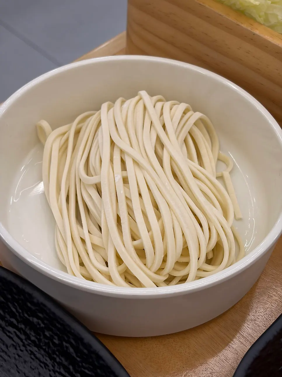 Pot of spicy broth with the basic table setting