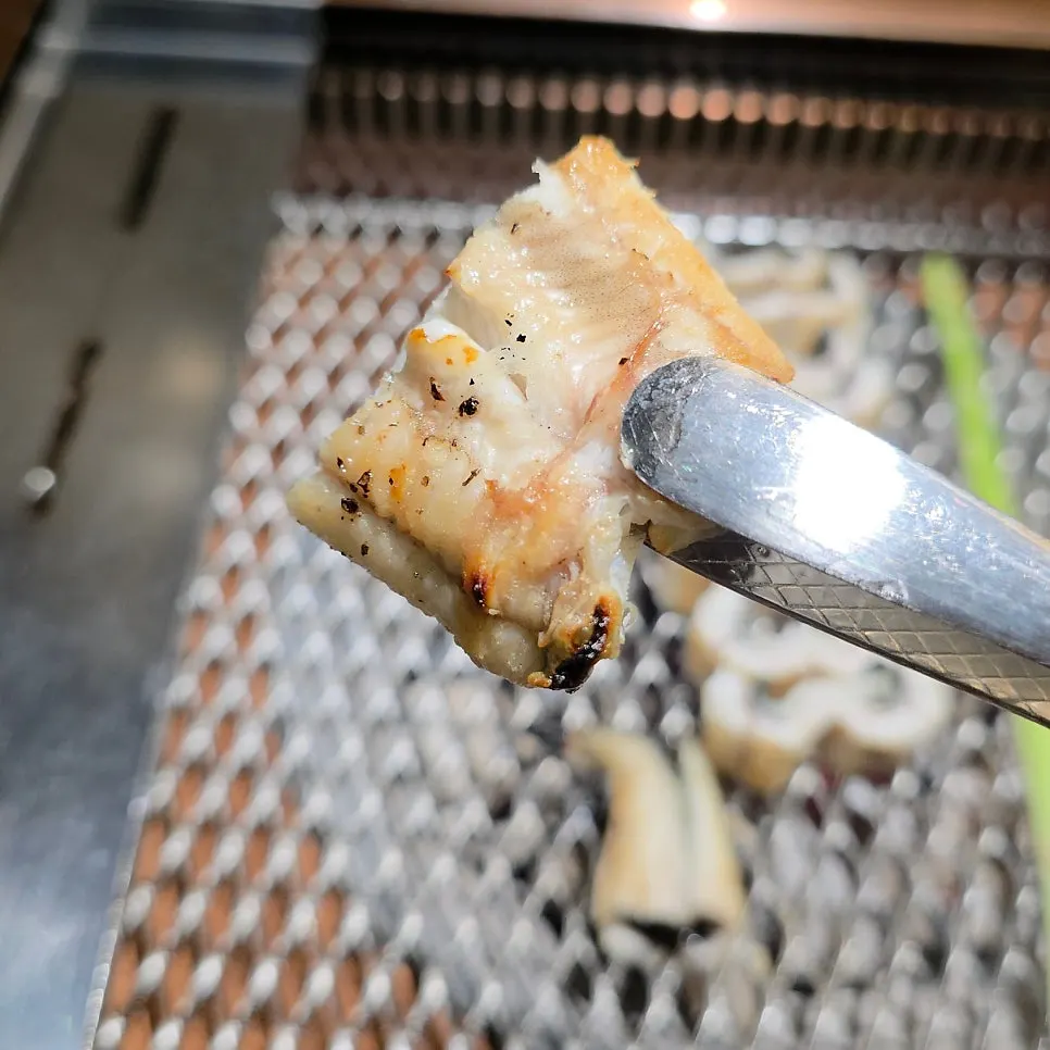 Eel on a charcoal grill with smoke vents