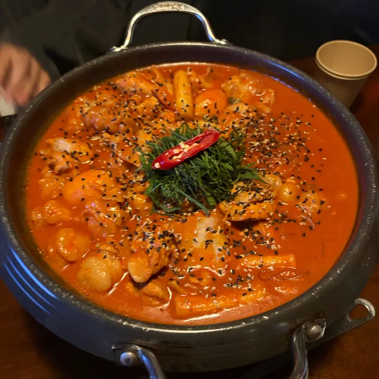 Pot of gopdoritang piled high with perilla leaves