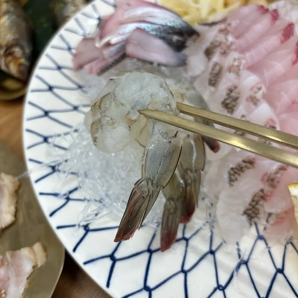 Plate of live octopus tossed in sesame oil