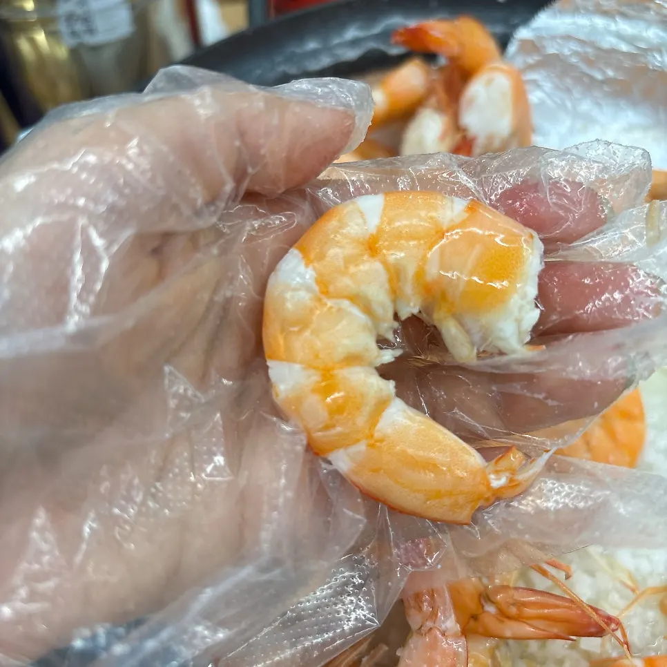 Palm-sized shrimp grilling on salt