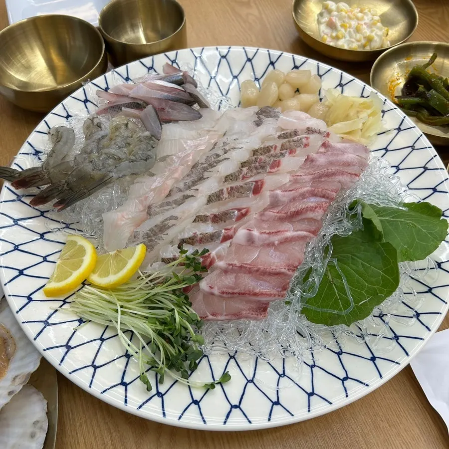 Mixed seafood platter with abalone, live octopus, sea cucumber, scallop, and sea squirt