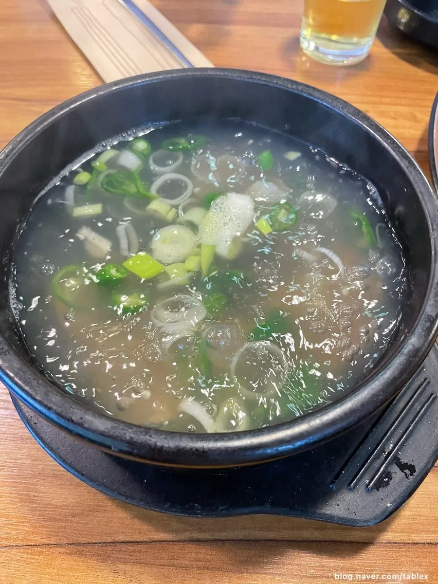 A bubbling stone pot of clam soup packed with clams