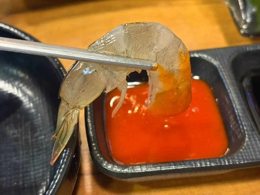 Raw shrimp sashimi served with seaweed and flying fish roe