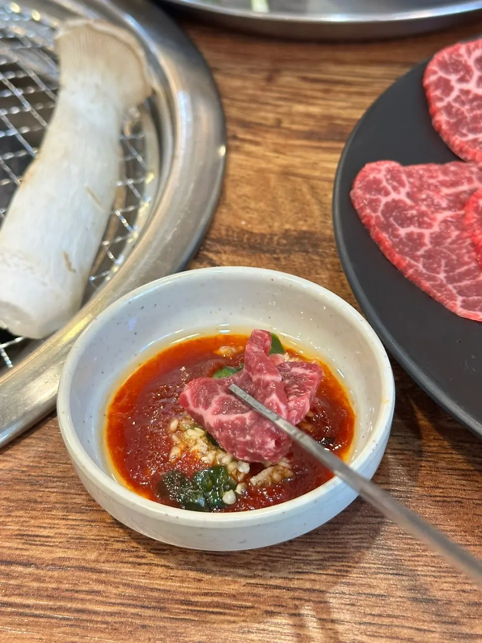 A piece of sashimi dipped in the special sauce