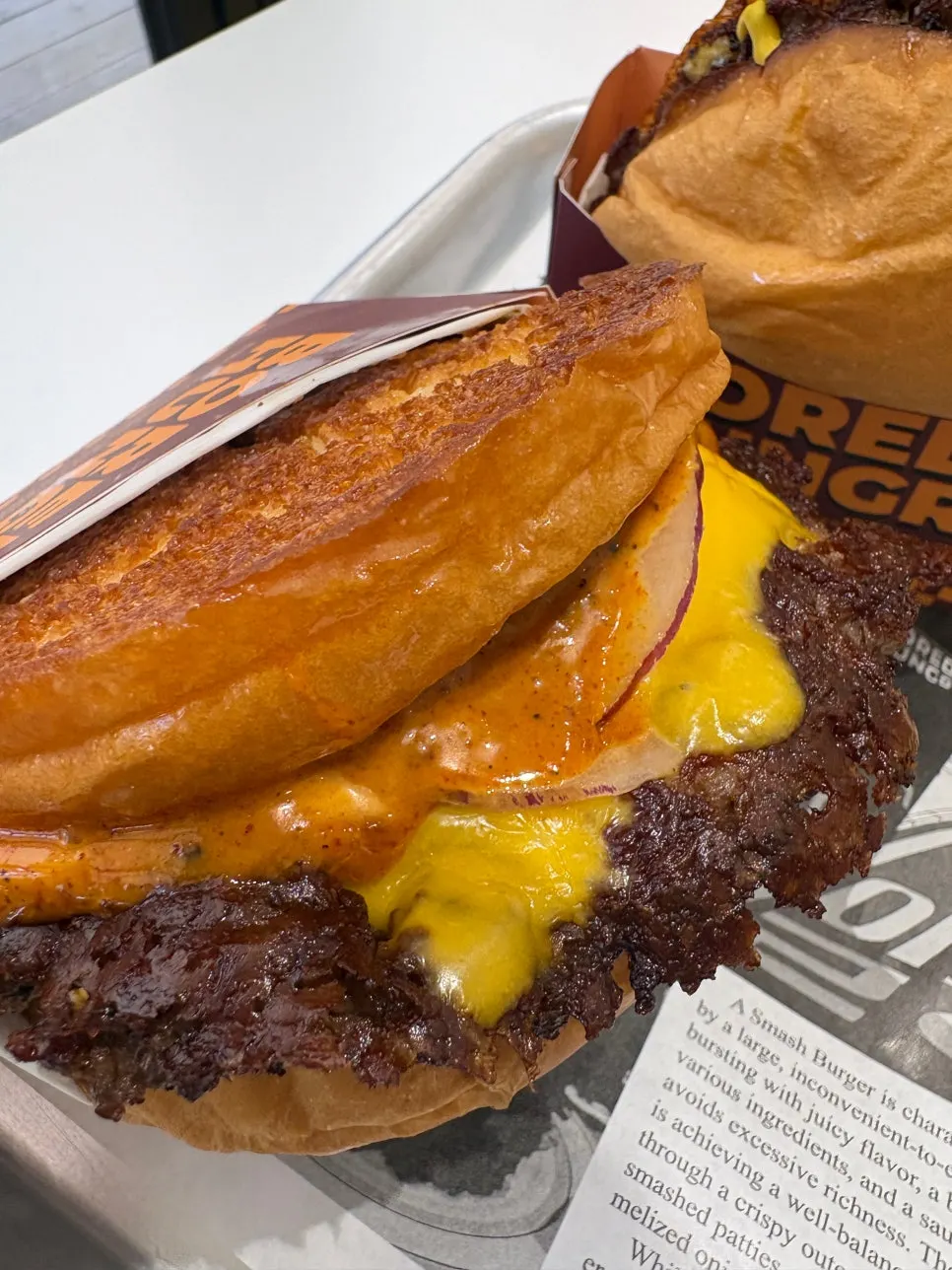 Cross-section of a burger showing thick patty and melted cheese