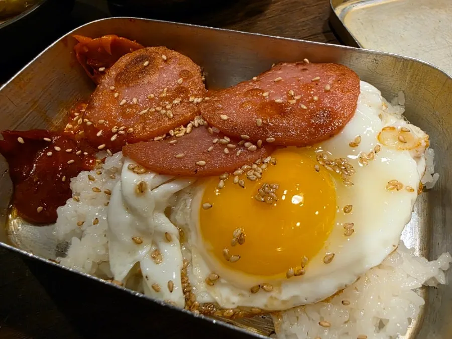 Nostalgic lunchbox topped with a fried egg