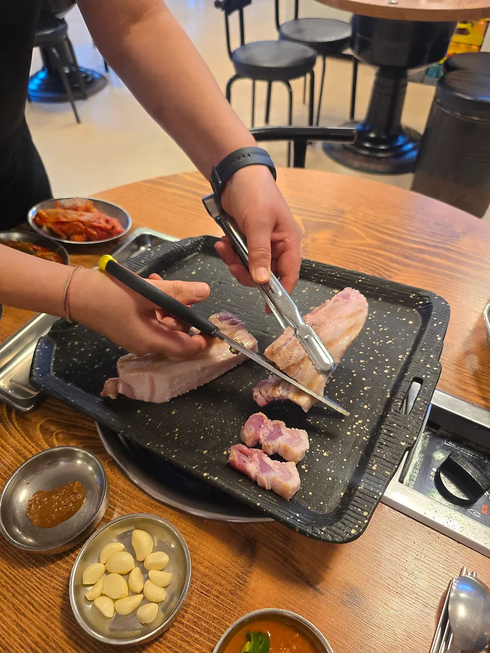 Staff cutting the whole pork belly