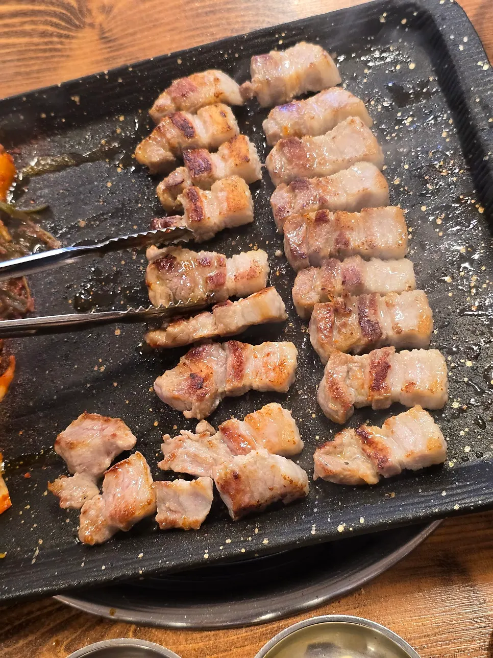 A piece of whole pork belly picked up with chopsticks