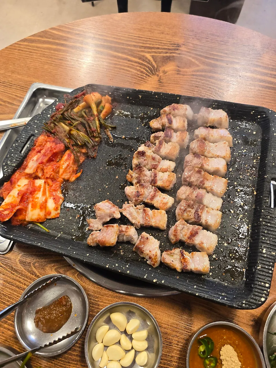 Plate of whole pork belly with side dishes