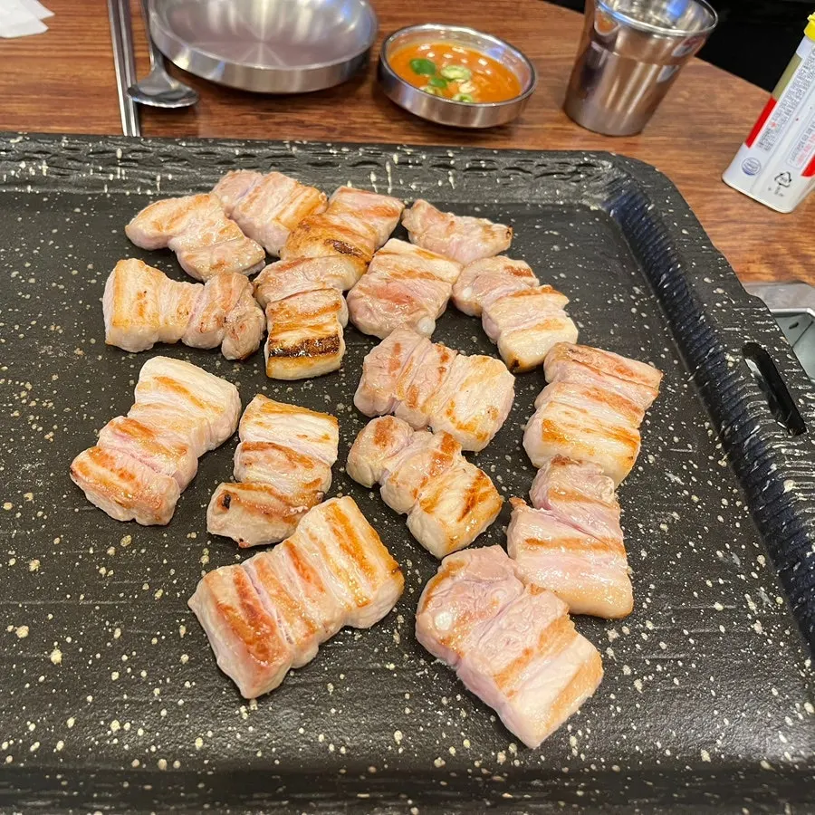 Thin frozen pork belly on the grill