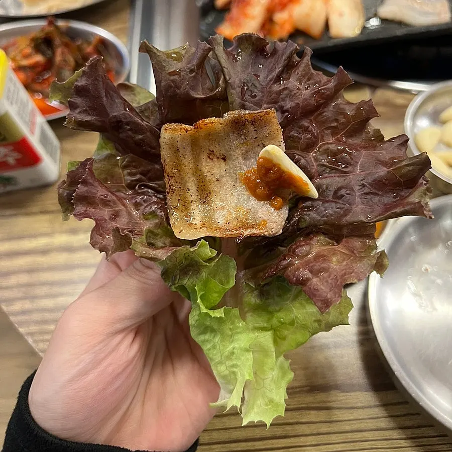 A piece of pork belly dipped in soybean powder sauce