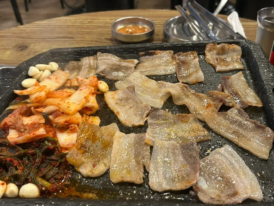 Pork belly grilling to golden brown on the pan