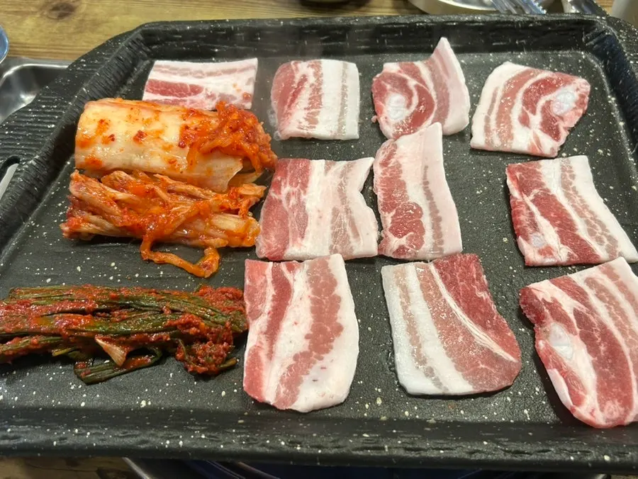 Three kimchi side dishes: green onion, napa cabbage, and washed kimchi