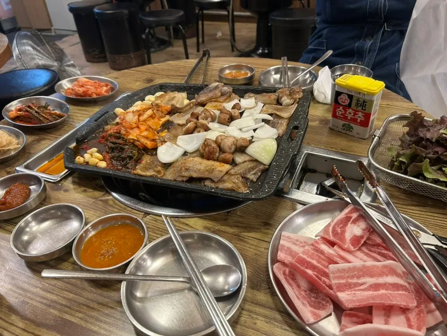A bite combining pork belly and bibim-myeon