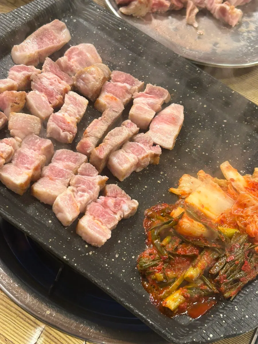 Pork belly sizzling on the grill