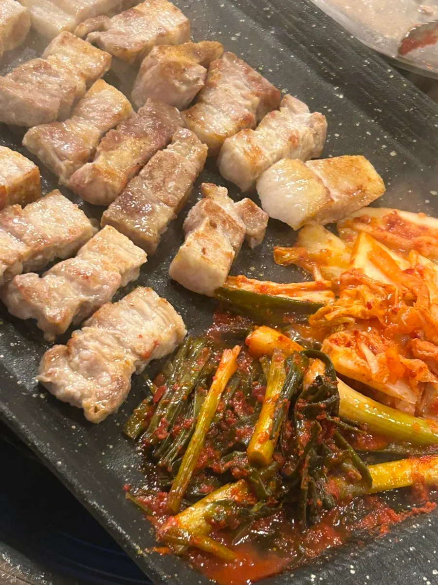 A piece of whole pork belly turning golden brown