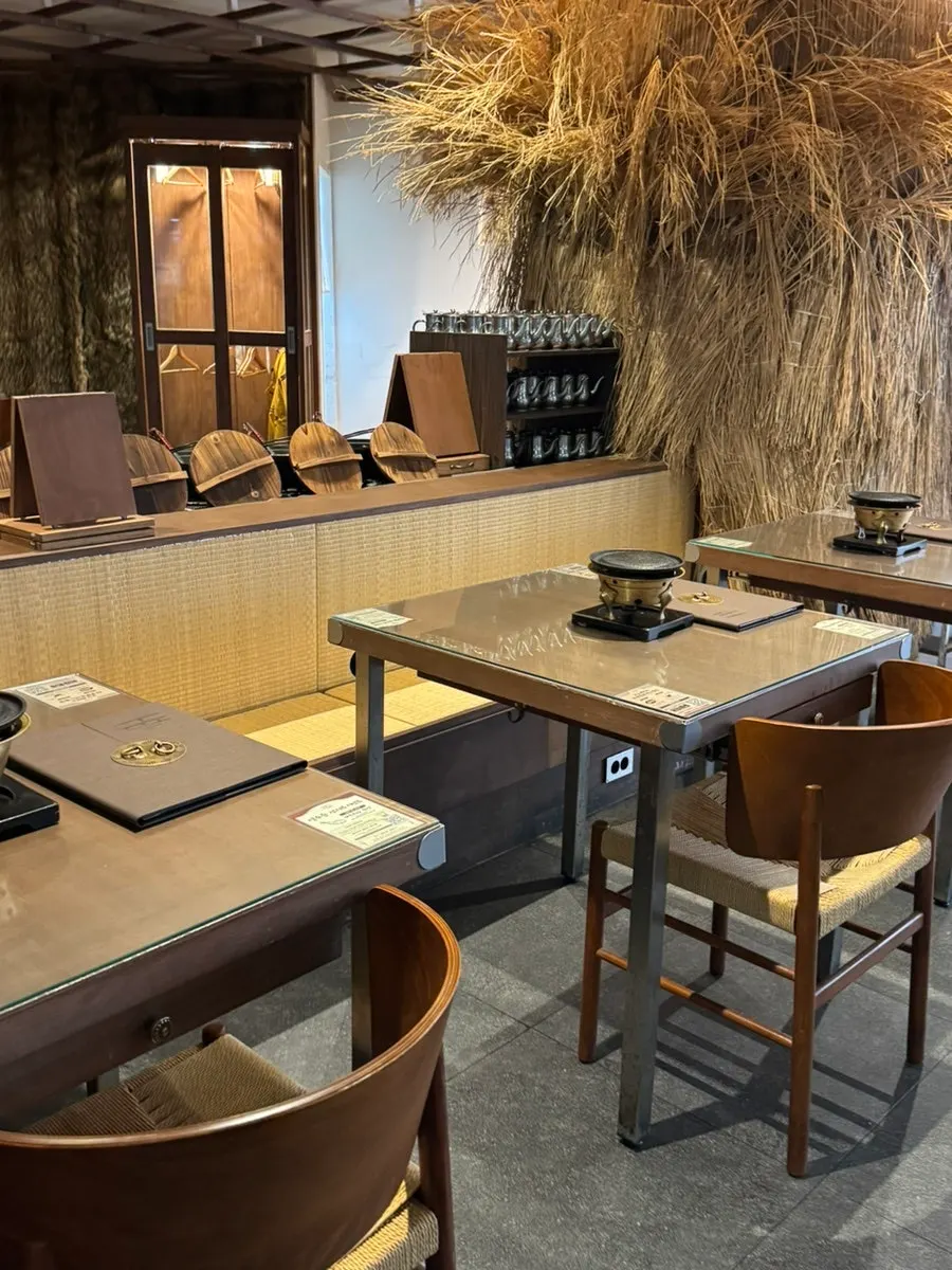 Restaurant interior with wood tones and straw decorations
