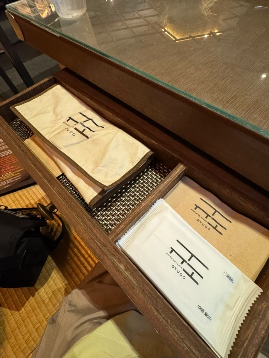 Cutlery pouch and toppings beneath the table