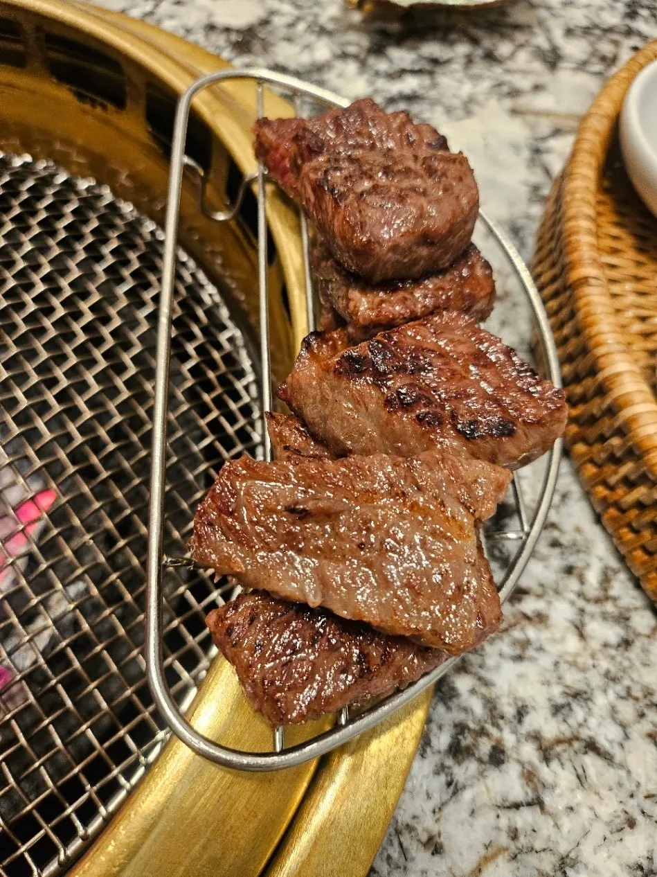 Staff member grilling hanwoo sirloin