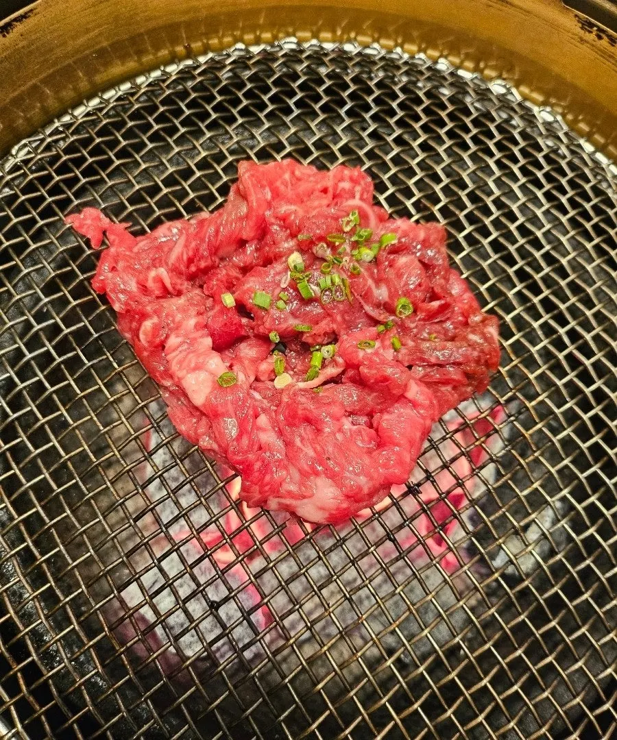 A piece of grilled sirloin dipped in coarse salt