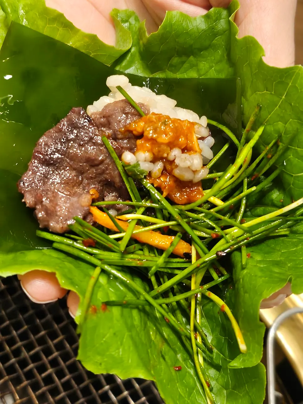 Seasoned bulgogi placed on a lettuce leaf