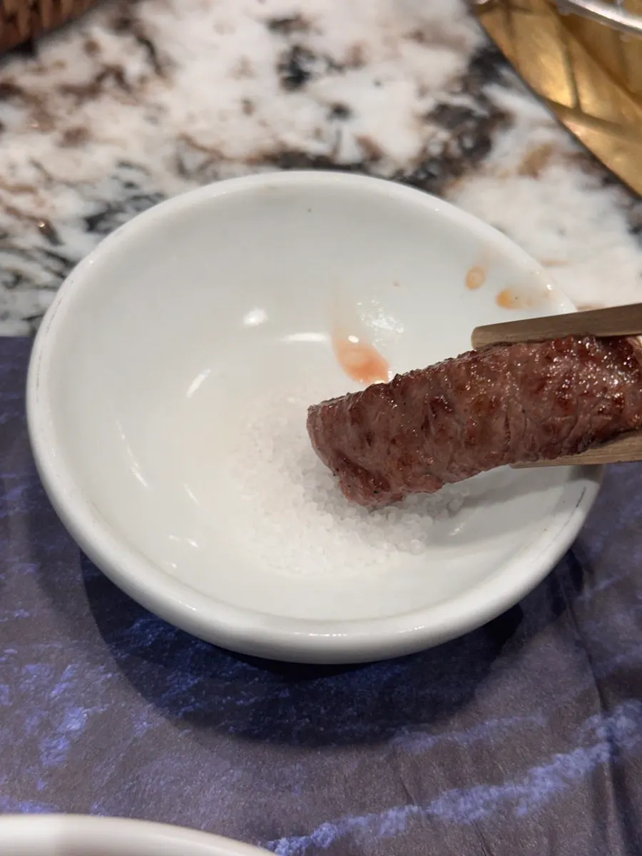 Marbled hanwoo sirloin being grilled by staff