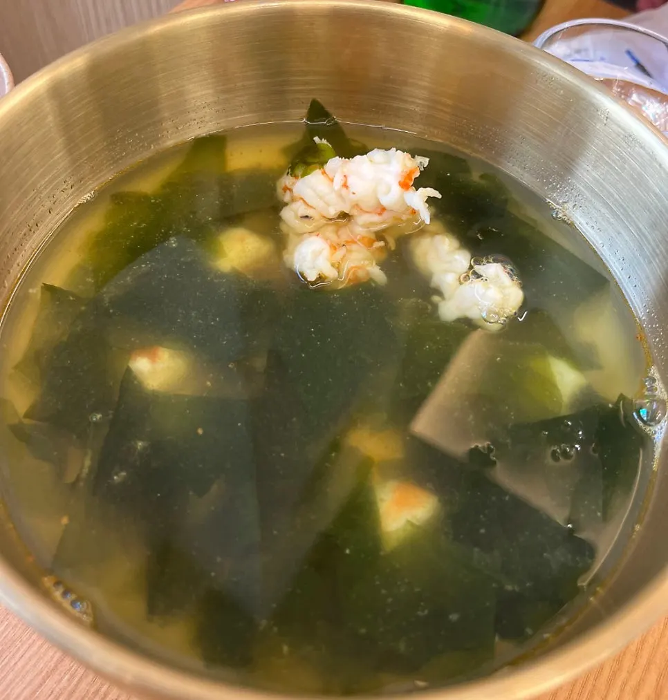A spoonful of abalone innards porridge
